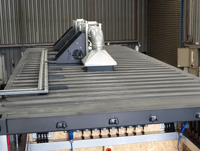 ATEX-rated ducted extractor fan installed on top of a converted shipping container, providing safe ventilation for electrical control and battery storage systems.