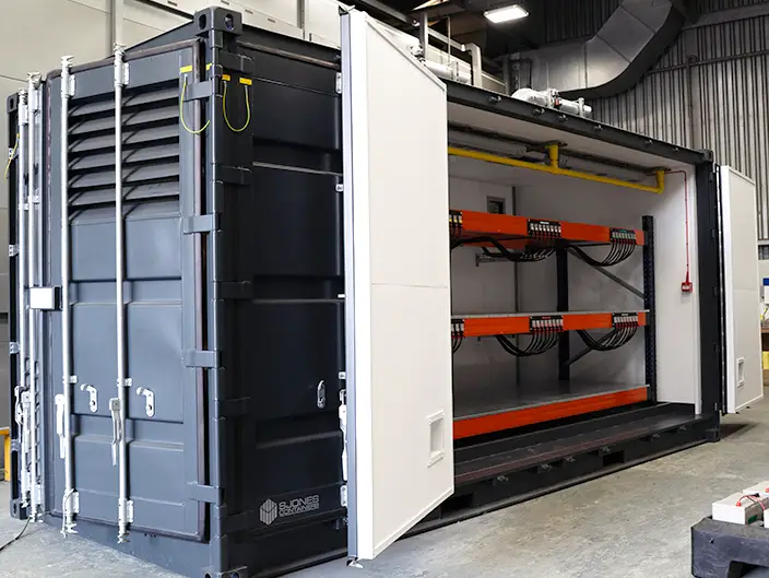 20ft converted shipping container designed as a lead-acid battery store, featuring secure ventilation, heavy-duty shelving, and integrated safety systems.