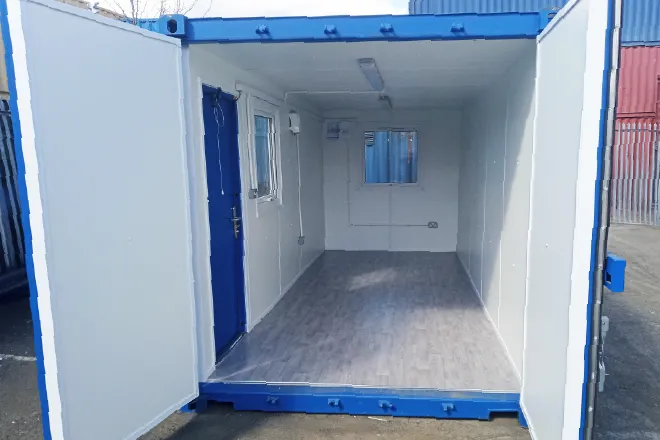 Converted shipping container with insulated interior, vinyl flooring, window, and secure steel door – perfect for compact site offices or welfare units.
