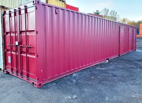 Large red multi-store storage container with three sections, positioned on tarmac ground in an outdoor yard.