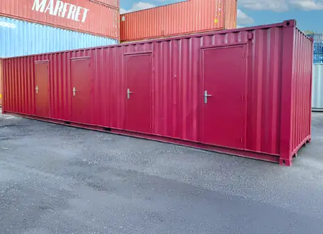 40ft red multi-store container with four personnel doors, positioned in an outdoor yard.