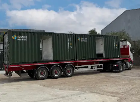 Topper storage container units being delivered on a flatbed lorry for installation at a self storage site.